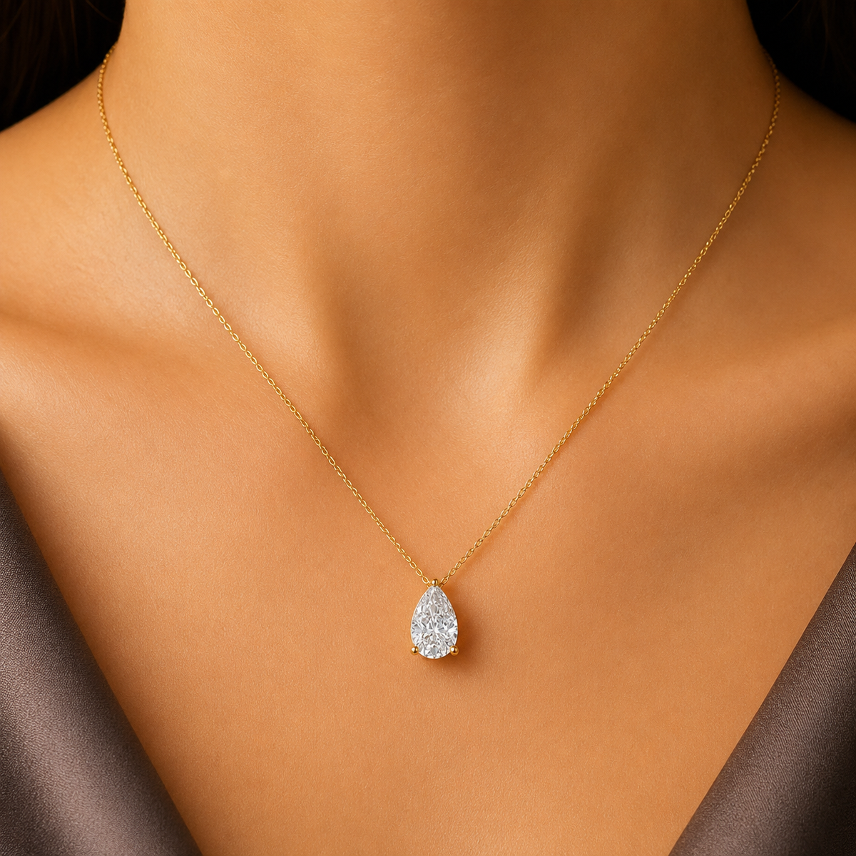 Elegant pear-cut diamond solitaire pendant, a stunning 14K or 18K gold charm featuring a brilliant teardrop diamond. Perfect for sophisticated daily wear or special anniversary gifts.  Discover high-quality, timeless fine jewelry today.
