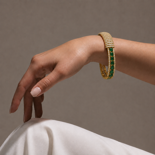 Discover the statement bangle, featuring a premium blend of vibrant emeralds and 203 brilliant-cut diamonds. Expertly crafted in 14K/18K gold, this luxurious cuff bracelet is perfect for bridal wear or high-end formal occasions. Elevate your fine jewellery collection with this artisan-designed, high-carat gold masterwork.