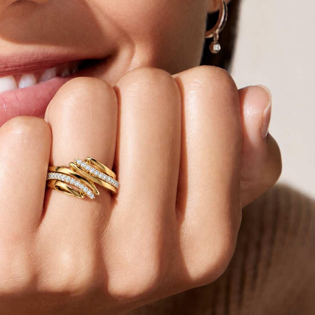 Shop the Entwined Synergy ring, a modern statement piece featuring 30 sparkling diamonds set in an elegant, overlapping design. Crafted in 14K & 18K gold. Perfect for those seeking unique, high-quality contemporary gold jewellery.