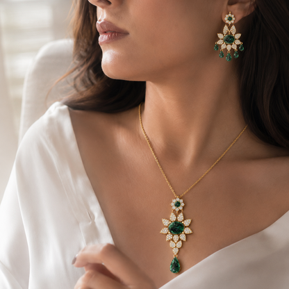 Indulge in luxury with this floral-inspired emerald and diamond jewelry set. Crafted in 18kt gold with 346 diamonds, this set includes a statement centerpiece and matching earrings. View model PS-4113.