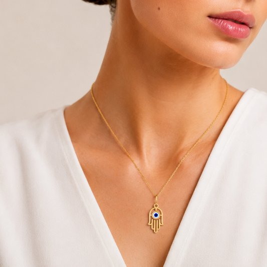 Discover the protective charm of this Hamsa Evil Eye pendant. Featuring a striking evil eye design set in high-quality 14K or 18K gold, this symbolic piece is a perfect everyday accessory. Shop handcrafted, meaningful gold jewellery online, ideal for gifting or personal style.
