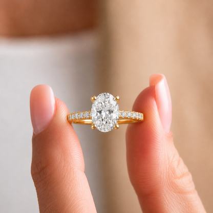 Searching for the perfect engagement ring that combines classic beauty with modern sparkle? Our Radiant Oval Solitaire Pave Ring is crafted to impress. This ring features a breathtaking, brilliant-cut oval diamond (1.99tw) as its centerpiece, which is known for its ability to make the finger appear longer and more slender.