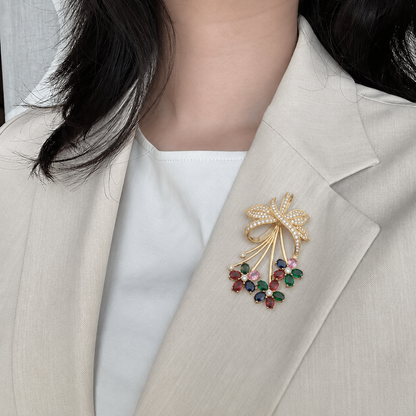 Discover The Floral Bouquet Multi-Gemstone & Diamond Statement Pendant, featuring a stunning ribbon design adorned with 99 diamonds and 15 vibrant oval gemstones. Handcrafted in 14K or 18K gold, this luxurious artisan piece is the ultimate accessory for those who love colorful, high-impact fine jewelry. 