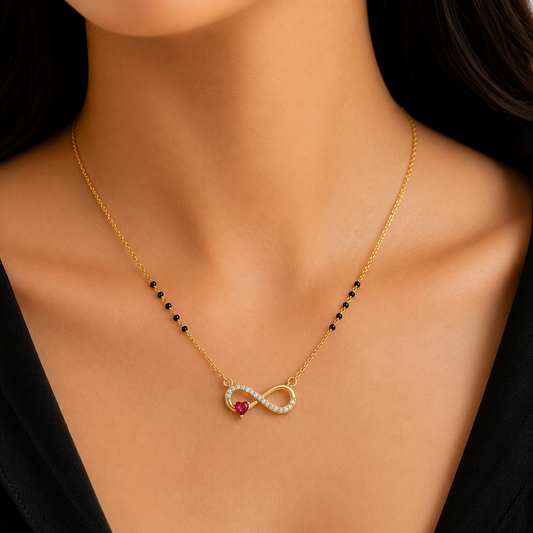The Infinite Heart Diamond Pendant, featuring an infinity loop set with 17 diamonds and a central heart-shaped ruby. Available in 14K or 18K gold, this artisan-crafted pendant is a perfect expression of eternal love.