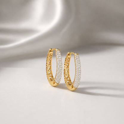 Discover The Luminary Pavé Arch Diamond Hoop Earrings, featuring an expansive oval design set with 156 brilliant diamonds and exquisite cutout craftsmanship. Available in 14K or 18K gold, these artisan-made hoops are the ultimate accessory for modern, high-fashion elegance. 