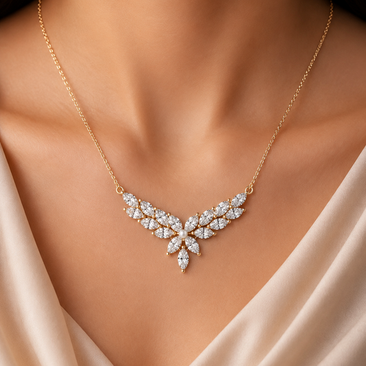 Highlight your bridal glow with The Majestic Marquise Leaf Arch Mangalsutra Pendant. Featuring 17 brilliant marquise diamonds arranged in a graceful 41mm vine silhouette, this 14K or 18K gold piece offers a breathtaking, nature-inspired take on traditional luxury. 