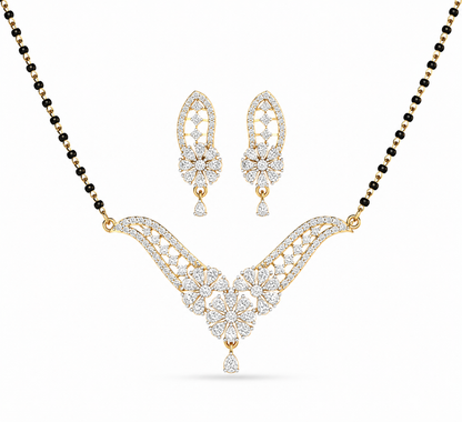 lluminate your traditional look with The Royal Fern Diamond Mangalsutra and Earring Set, a masterpiece featuring a V-shaped pendant and matching earrings adorned with 95 diamonds. Crafted in 14K or 18K gold, this set brings unmatched grace and luxury to every bridal moment. 
