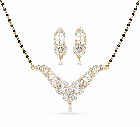 lluminate your traditional look with The Royal Fern Diamond Mangalsutra and Earring Set, a masterpiece featuring a V-shaped pendant and matching earrings adorned with 95 diamonds. Crafted in 14K or 18K gold, this set brings unmatched grace and luxury to every bridal moment. 