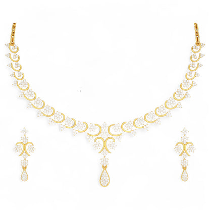 Yellow gold necklace and matching drop earrings set featuring delicate floral diamond clusters and a teardrop pendant.