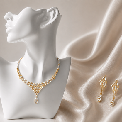 Yellow gold and diamond V-shaped lattice necklace with pearl strands, a teardrop drop, and matching kite-shaped dangle earrings