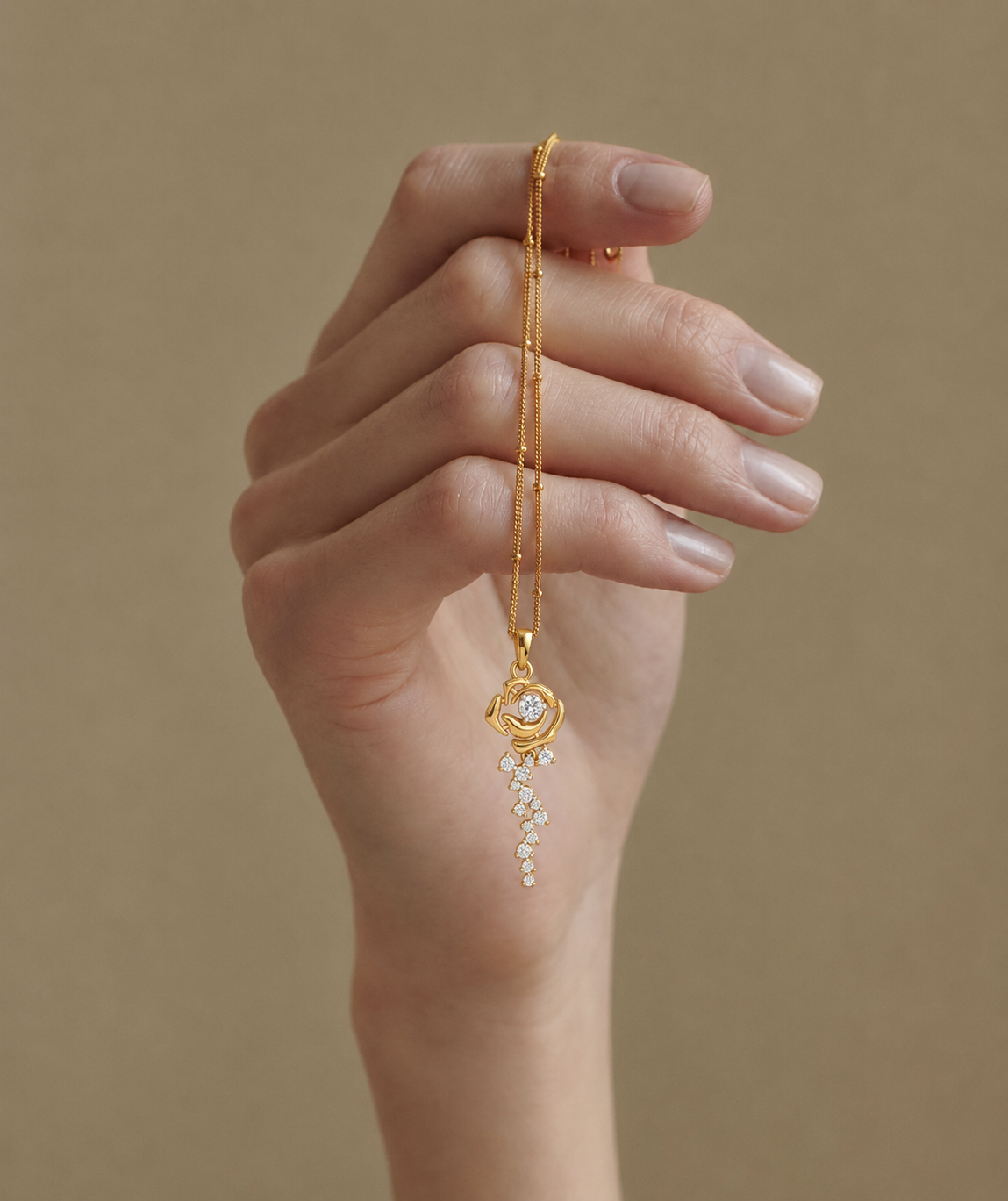The Forever Rose pendant in yellow gold featuring a diamond center and a cascading trail of falling petal diamonds.