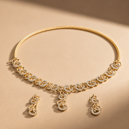 Yellow gold necklace and matching drop earrings set featuring interlocking swirl links studded with diamonds and a tiered central drop.