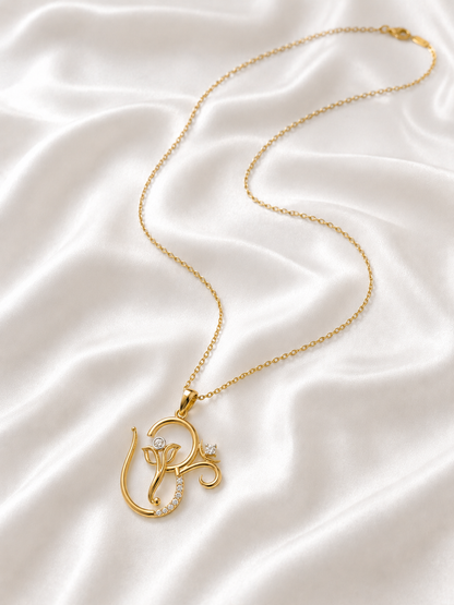 Gold pendant necklace shaped like the Om symbol and Lord Ganesha, decorated with small diamond.