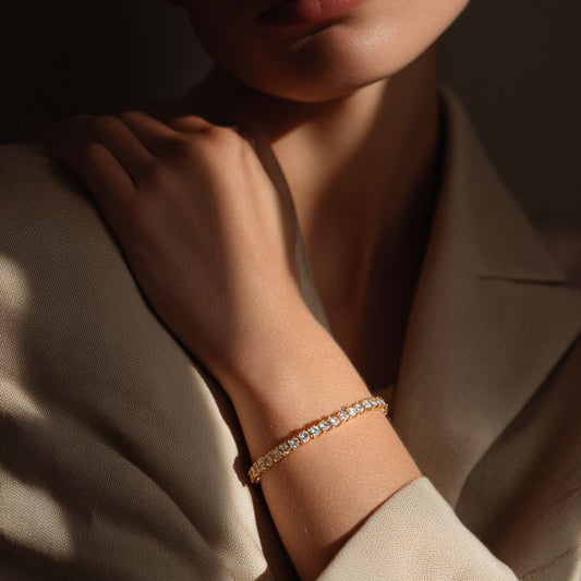A yellow gold tennis bracelet featuring a single row of continuous round-cut diamonds, displayed as a full circle against a solid white background.