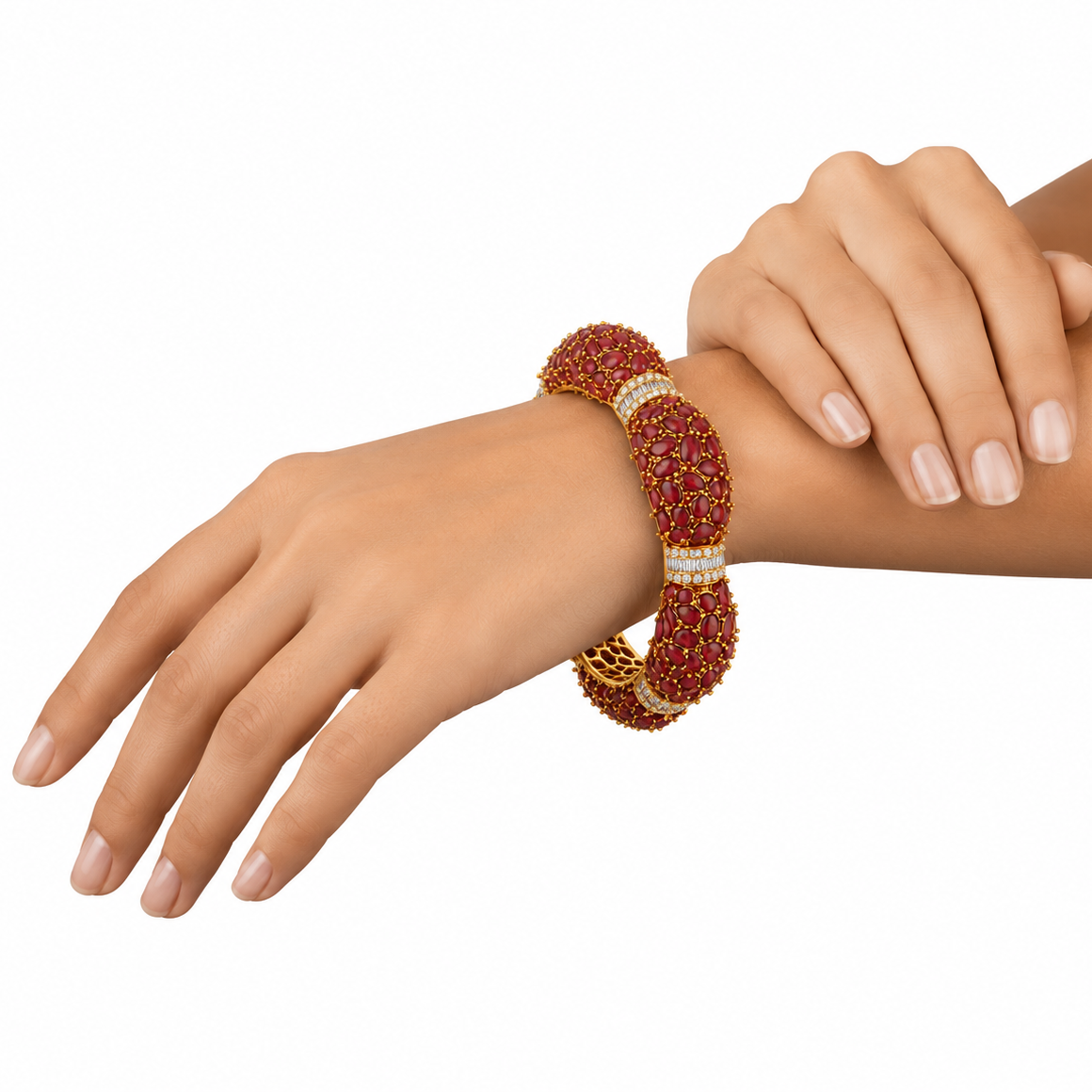 A thick yellow gold statement bangle bracelet heavily paved with smooth red ruby cabochons, divided by horizontal bands of white baguette diamonds