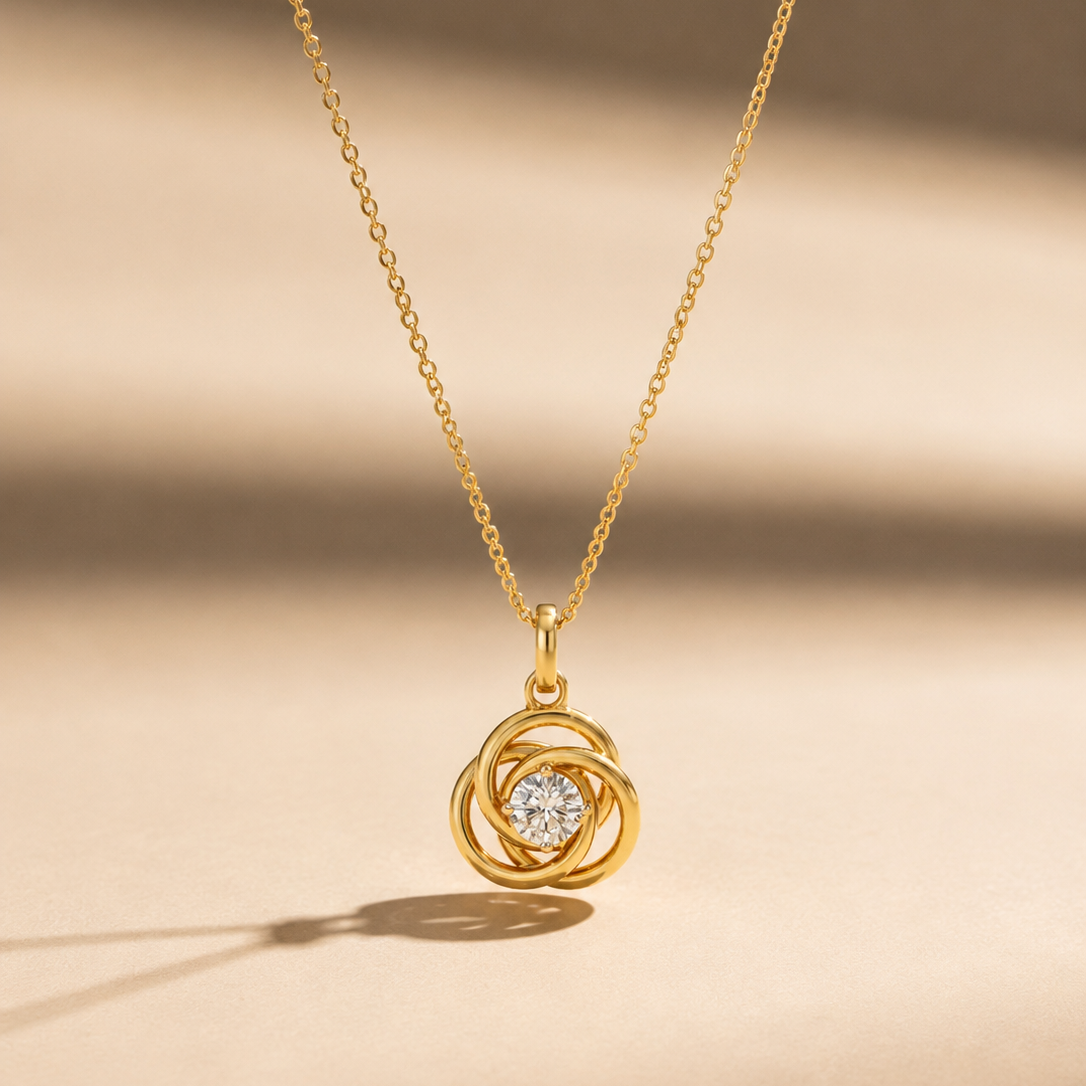 A yellow gold pendant necklace with a twisted spiral design featuring a single large round diamond sparkling in the center