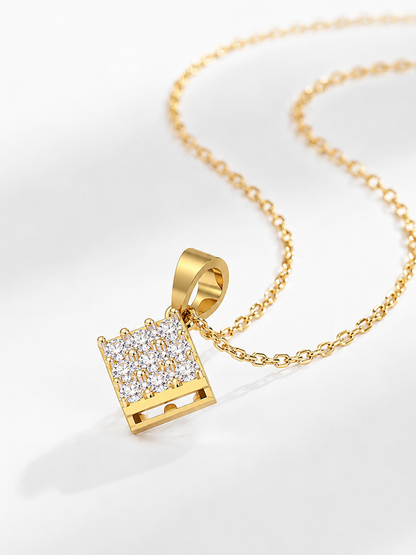 A yellow gold pendant necklace featuring a small square shape packed with a cluster of tiny sparkling diamonds.