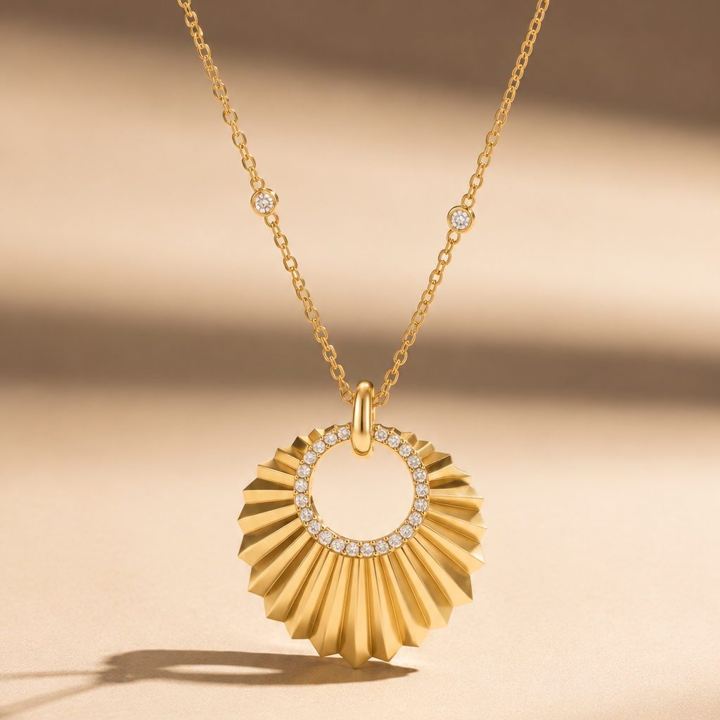 A yellow gold necklace with a round pendant shaped like a sunburst, featuring a hollow circle in the center lined with small diamonds.