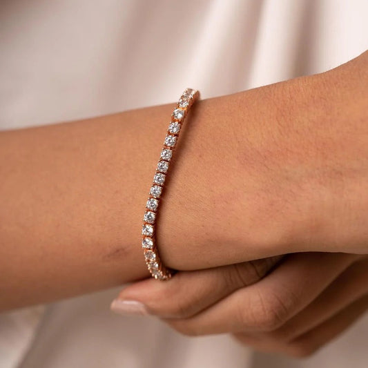 A single row round diamond tennis bracelet in a rose gold setting