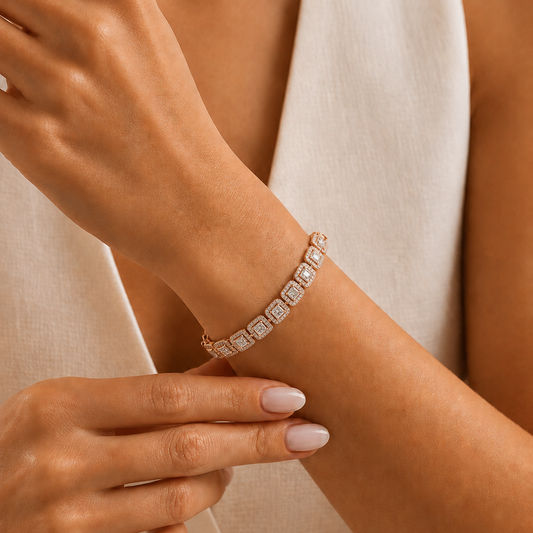 A rose gold bracelet featuring a continuous row of repeating square links, each with a princess-cut diamond center surrounded by a diamond halo frame.